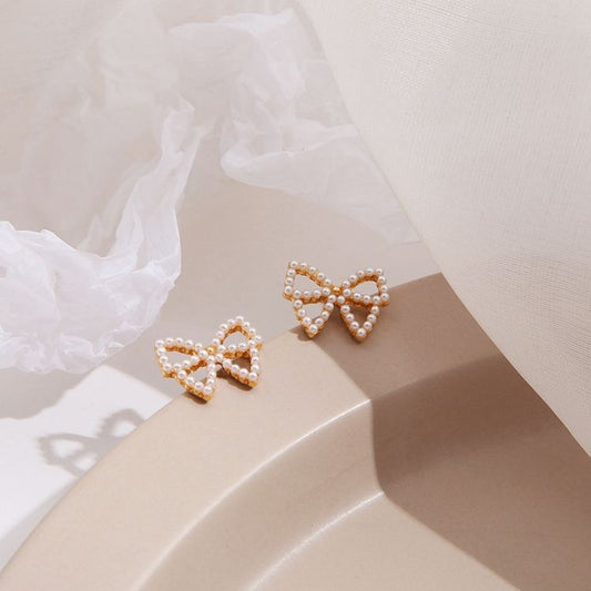 Bowknot Hollow Mystic Stud Earrings