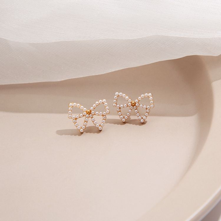 Bowknot Hollow Mystic Stud Earrings
