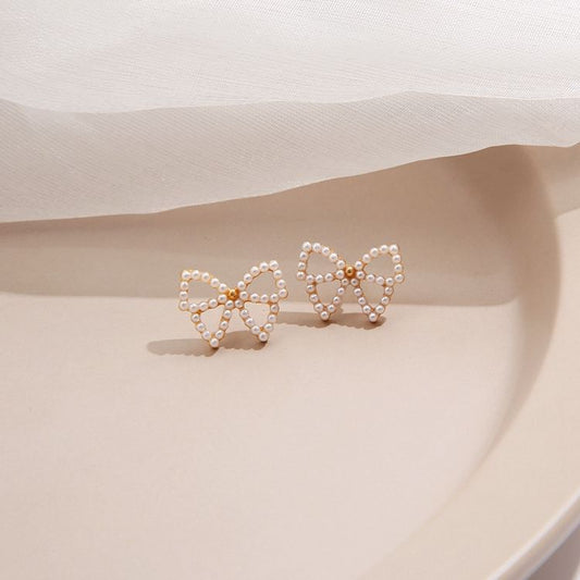 Bowknot Hollow Mystic Stud Earrings
