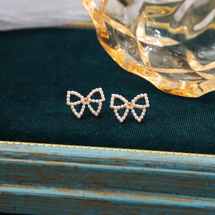 Bowknot Hollow Mystic Stud Earrings